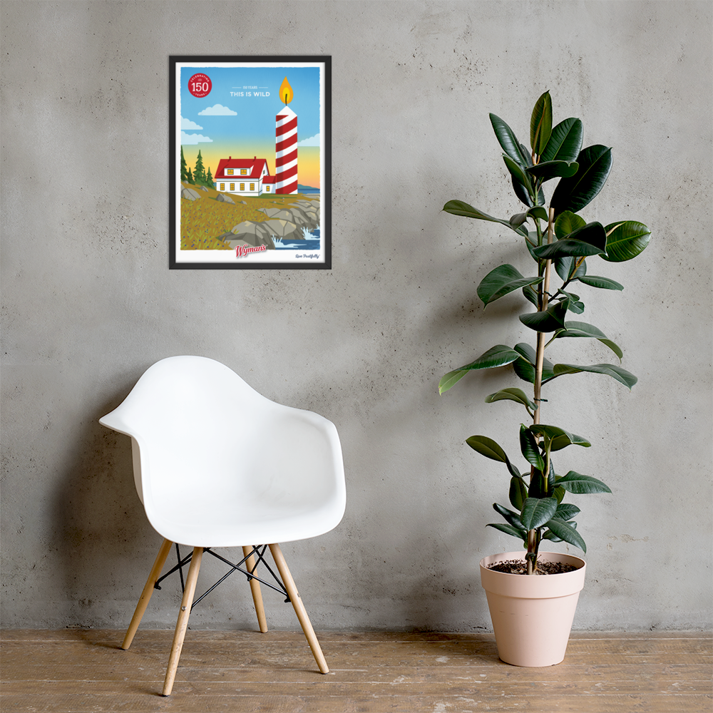 A framed custom Shop Wyman's poster of a lighthouse on a wall next to a chair.