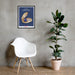 A framed Behold Mother Nature's Tiniest Kept Secret Poster of a blueberry on a wall next to a chair from Shop Wyman's.