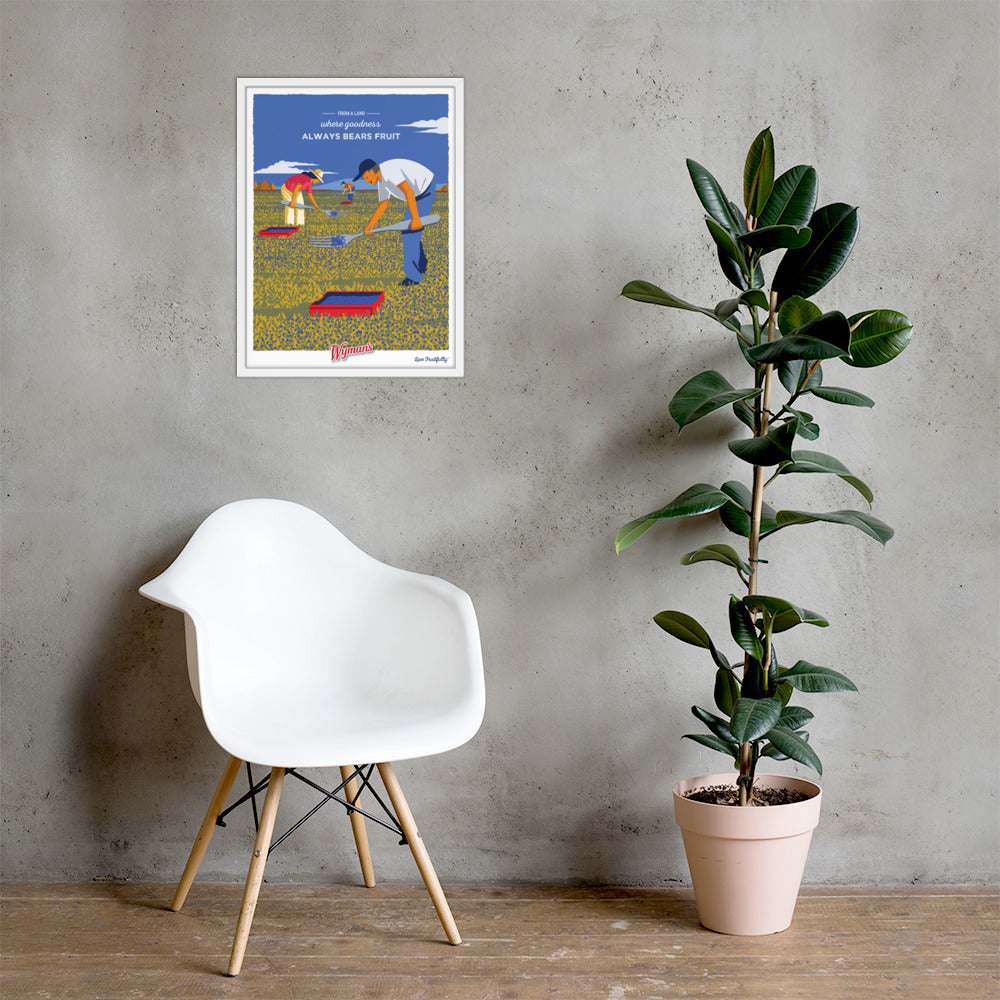 A white chair next to a wall with a Shop Wyman's From a Land Where Goodness Always Bears Fruit Poster.