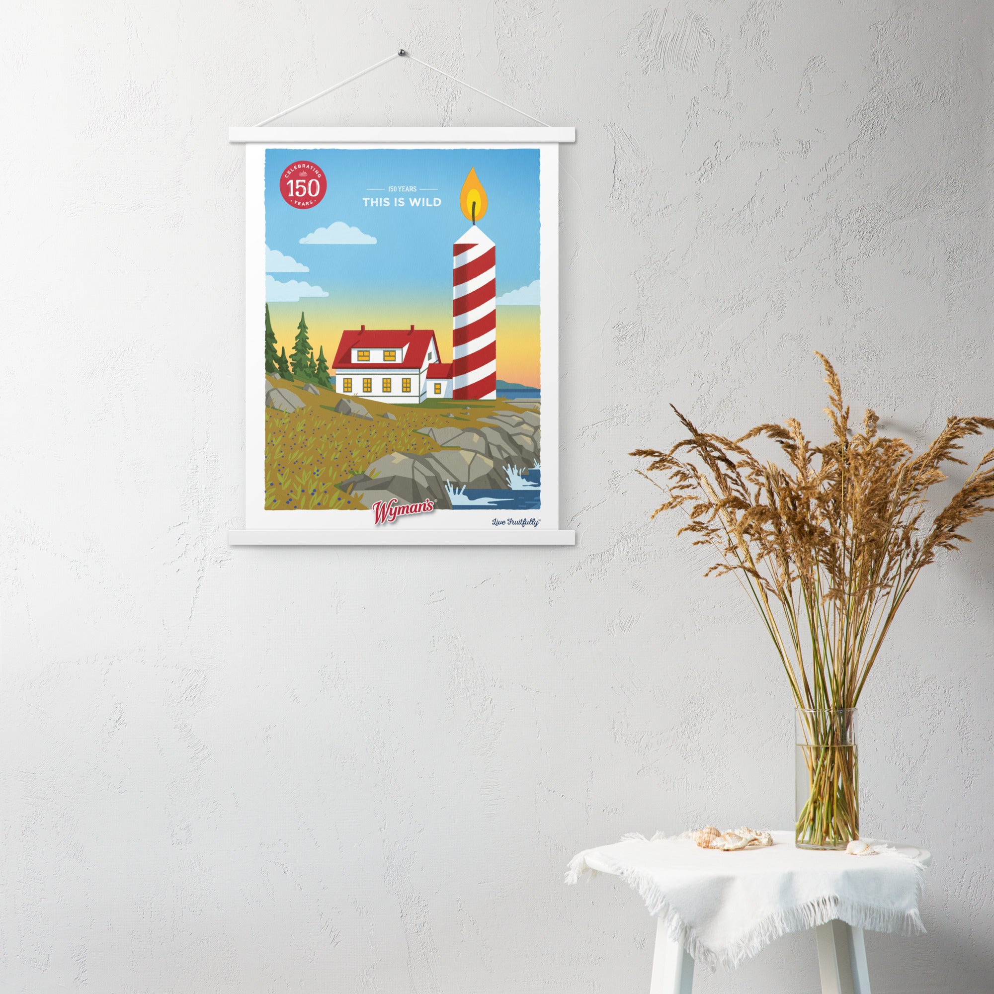 A Shop Wyman's custom poster of a lighthouse hanging on a wall featuring the 150 Years, This is Wild Poster.