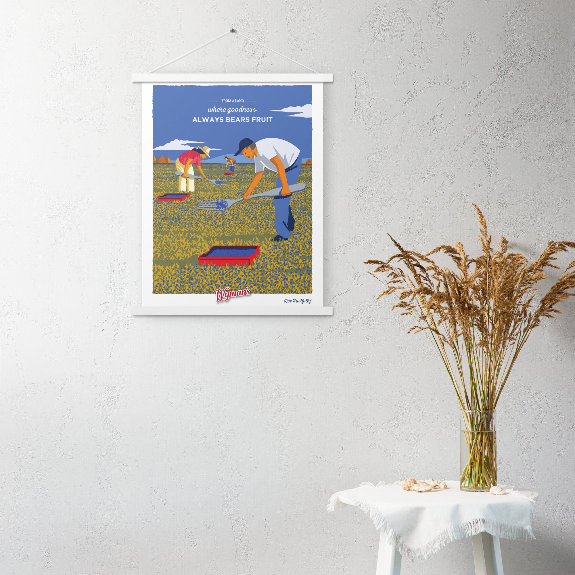 A Shop Wyman's "From a Land Where Goodness Always Bears Fruit" poster with an image of a man in a field of blueberries.
