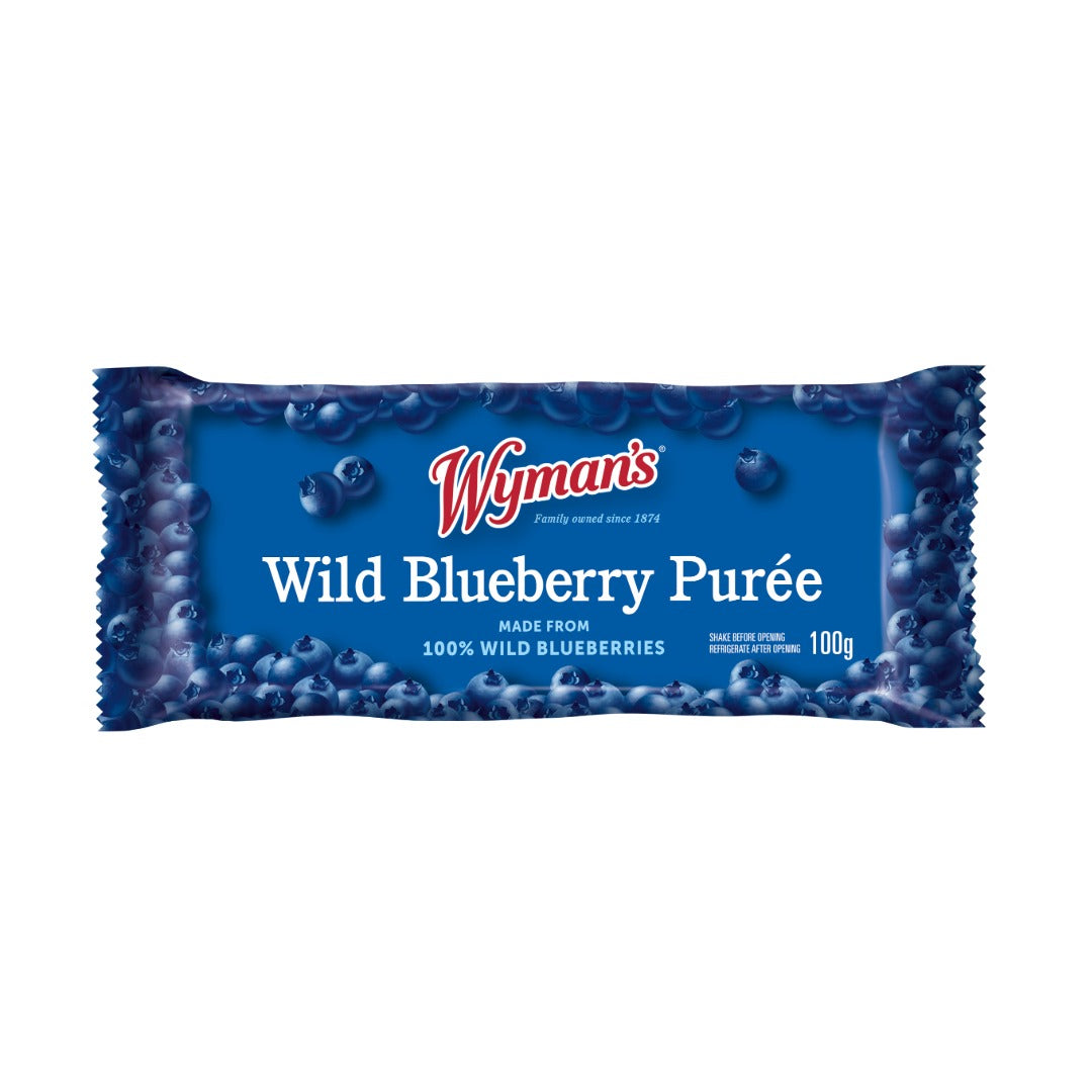 A blue 100g rectangular package of Wyman’s Wild Blueberry Purée smoothie pouch displays wild blueberry images and text stating it is made from 100% wild blueberries.