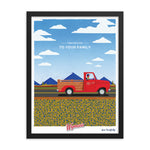 A framed print of the From Our Fields to Your Family Poster with a red truck driving down the road by Shop Wyman's.