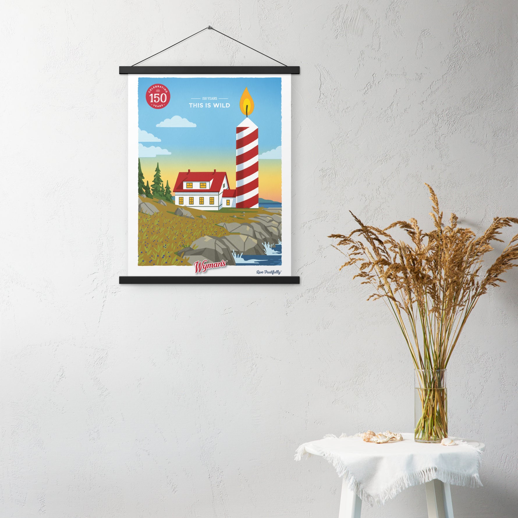 A custom 150 Years, This is Wild Poster of a lighthouse hanging on a wall from Shop Wyman's.