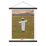 A Shop Wyman's In Concert with Nature Since 1874 Poster of a man flying a bee in a field with custom printing finishes.