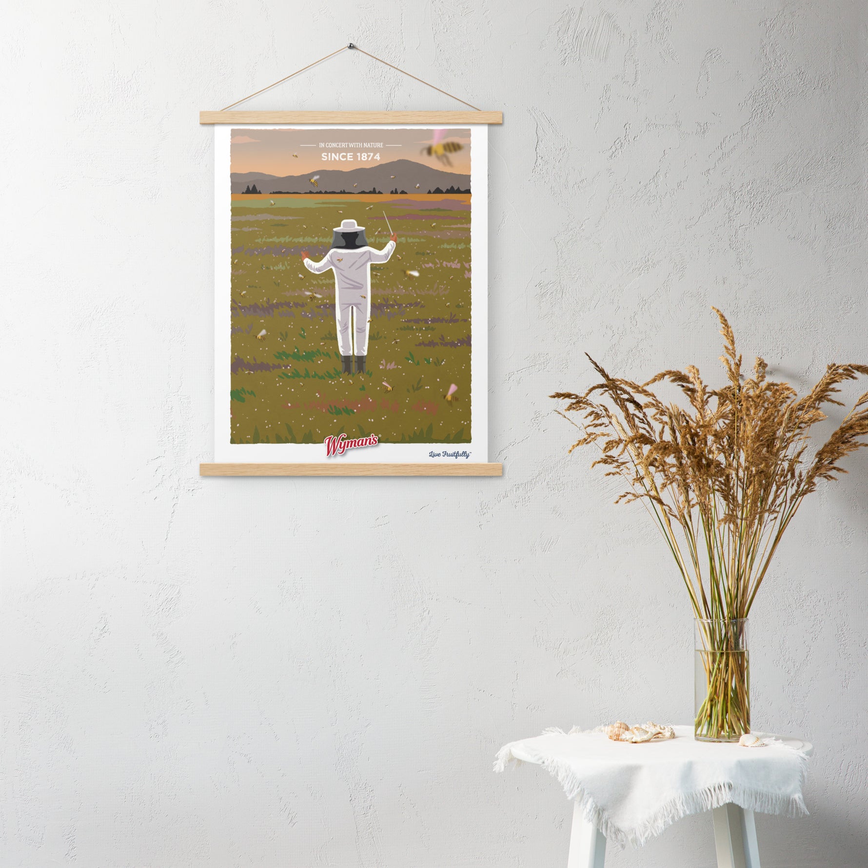 A Shop Wyman's In Concert with Nature Since 1874 Poster hanging on a wall with a person standing in a field.