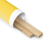 A yellow tube with custom printing finishes and a white background of "The Sweetest Things in Life are Right Here for the Picking Poster" by Shop Wyman's.