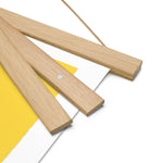 A wooden frame with a yellow "The Sweetest Things in Life are Right Here for the Picking" poster by Shop Wyman's, showcasing custom printing finishes.