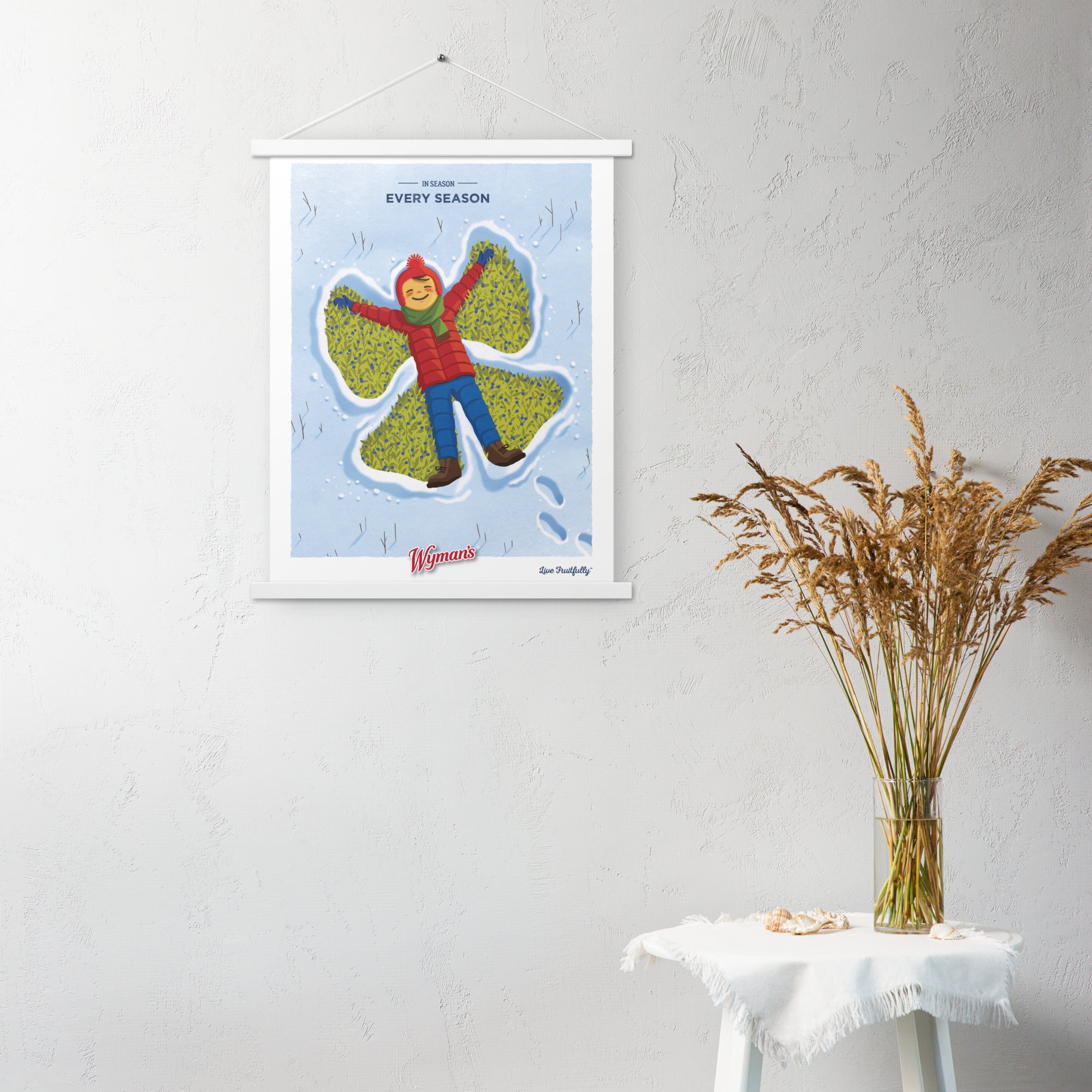A Shop Wyman's "In Season, Every Season" poster with a picture of a bird hanging on a wall, enhanced by unique printing finishes.