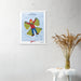 A Shop Wyman's "In Season, Every Season" poster with a picture of a bird hanging on a wall, enhanced by unique printing finishes.