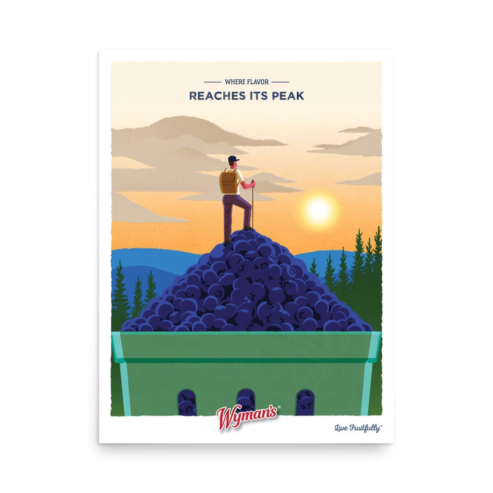 Bring home the "Where Flavor Reaches its Peak Poster"—featuring a person atop a giant blueberry pile with mountains and sunset. Wyman's logo below. Ideal wall art or custom poster for any blueberry lover!.